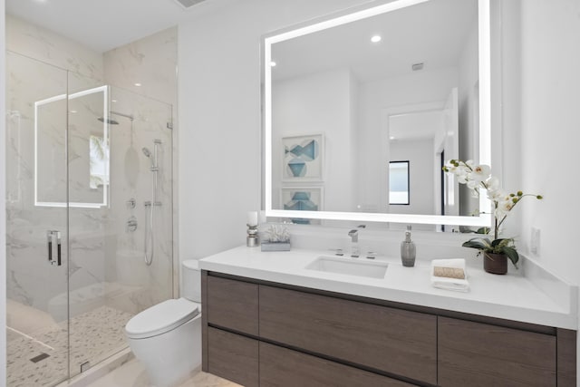 full bath with a marble finish shower, recessed lighting, toilet, and vanity