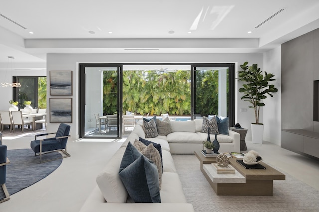 living area with recessed lighting, concrete flooring, and a wealth of natural light