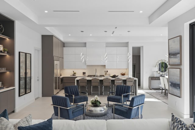 living room featuring recessed lighting and finished concrete flooring