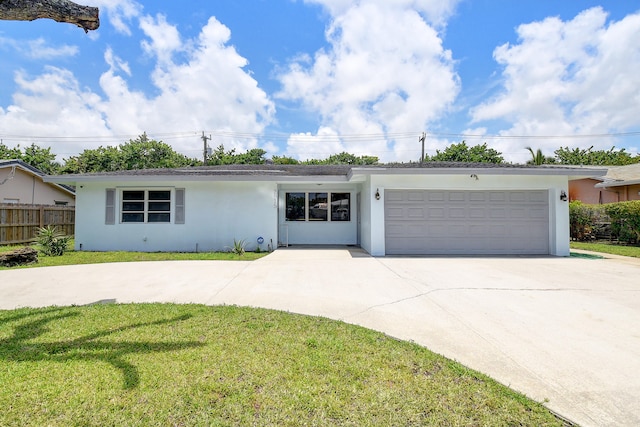 single story home with a front yard and a garage