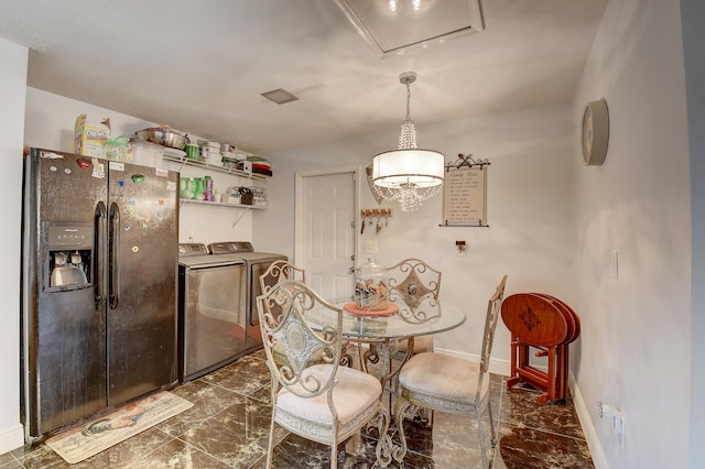 tiled dining room featuring independent washer and dryer