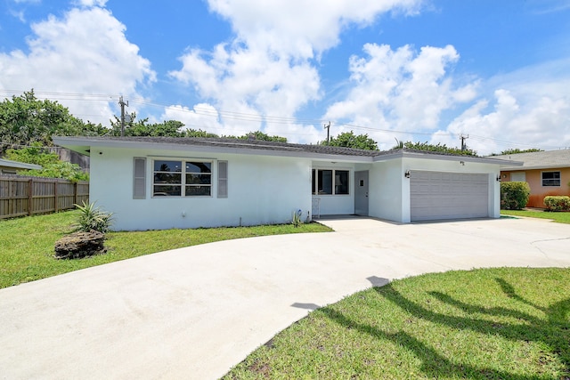 single story home featuring a front lawn and a garage