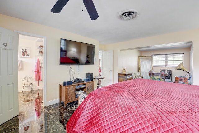 bedroom with dark tile floors and ceiling fan