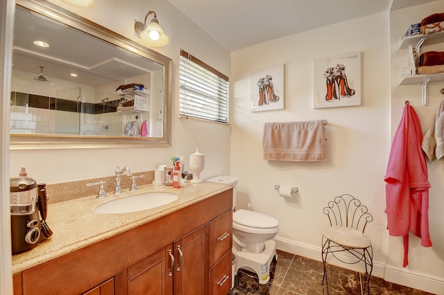 bathroom with an enclosed shower, vanity, tile floors, and toilet