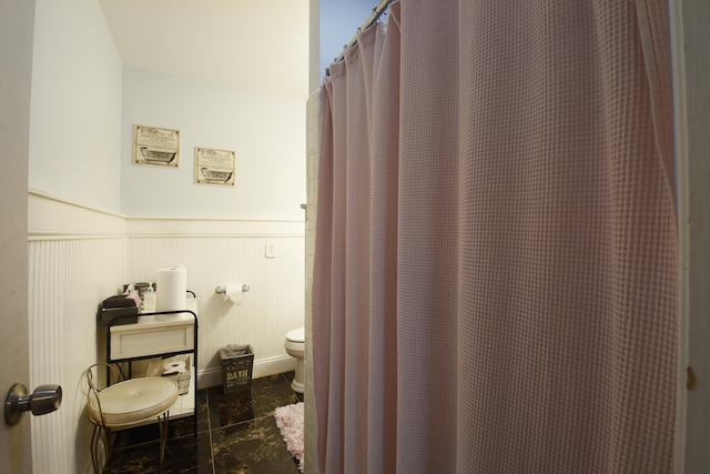 bathroom featuring toilet and tile flooring