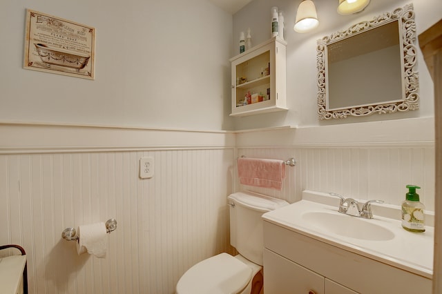 bathroom with toilet and large vanity