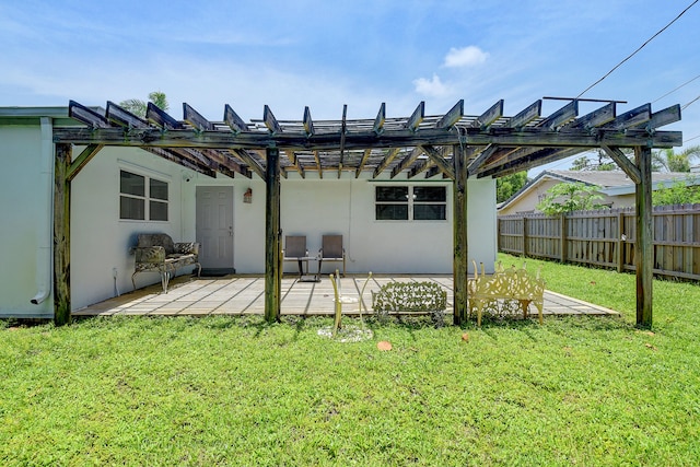 rear view of house featuring a lawn, a pergola, and a wooden deck