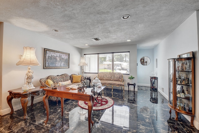 living room with a textured ceiling and dark tile floors