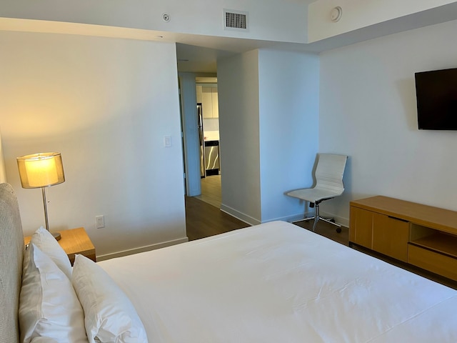 bedroom featuring dark hardwood / wood-style flooring