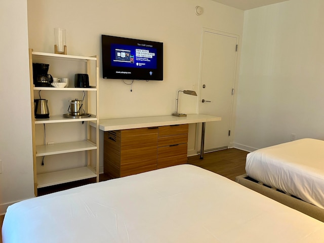 bedroom with dark wood-type flooring