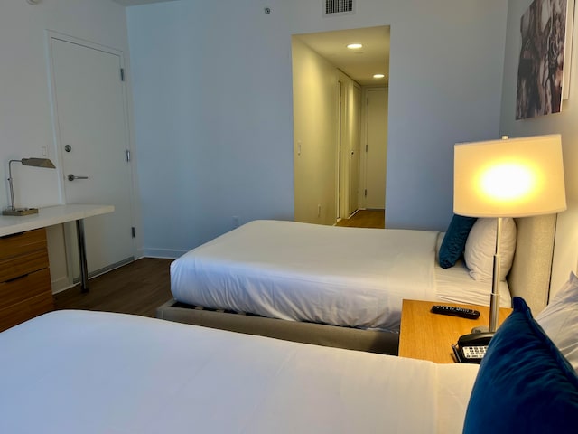 bedroom with dark wood-type flooring