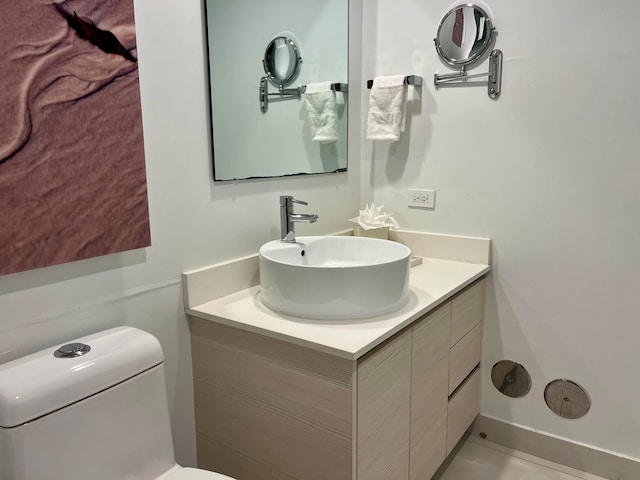 bathroom featuring toilet and vanity