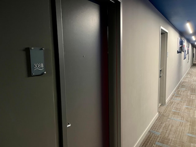 hallway featuring light carpet