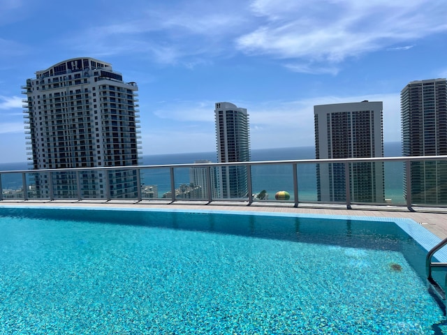 view of pool with a water view