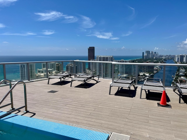 view of patio with a balcony and a water view