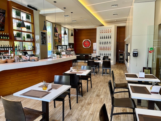 interior space featuring pendant lighting and light hardwood / wood-style flooring