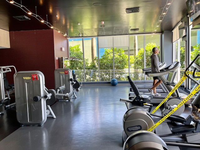 gym featuring floor to ceiling windows