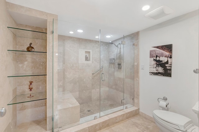 bathroom featuring walk in shower, tile patterned floors, and toilet