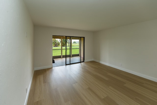 unfurnished room with light hardwood / wood-style flooring