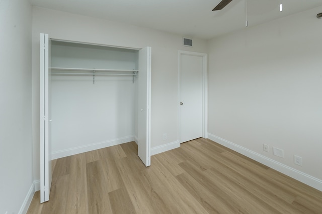 unfurnished bedroom featuring a closet, ceiling fan, and light wood-type flooring