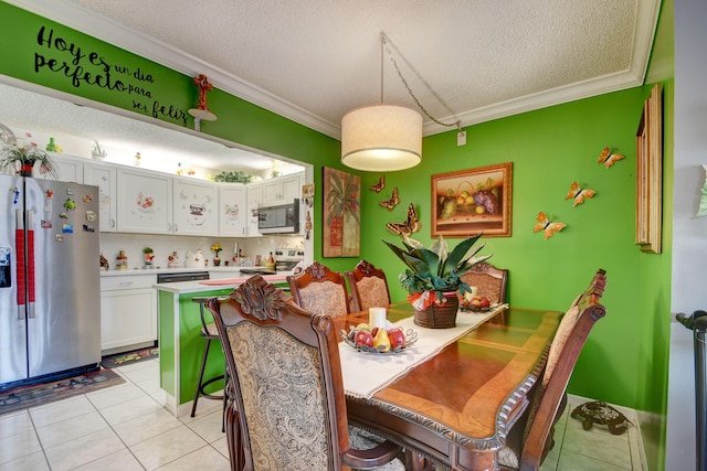 tiled dining area featuring ornamental molding and a textured ceiling