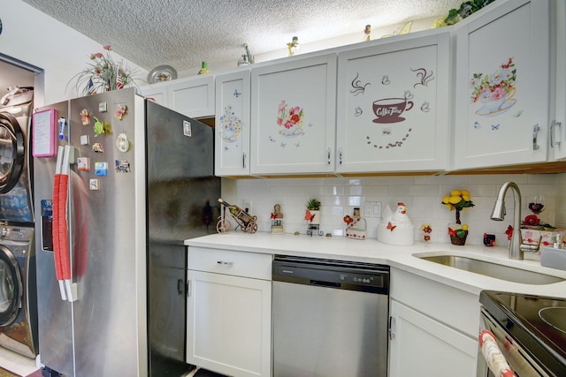 kitchen featuring backsplash, stacked washer / drying machine, sink, stainless steel appliances, and a textured ceiling