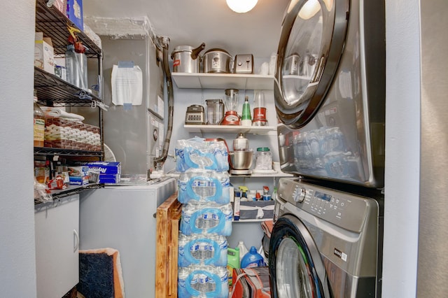 clothes washing area featuring stacked washer and dryer