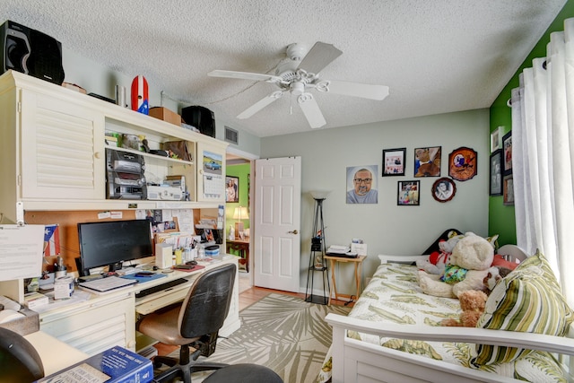 office featuring a textured ceiling and ceiling fan