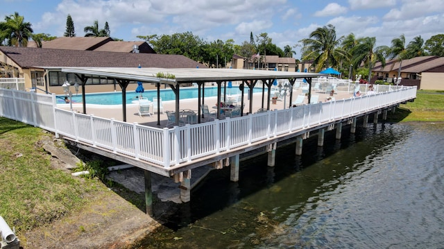 dock area with a community pool and a water view