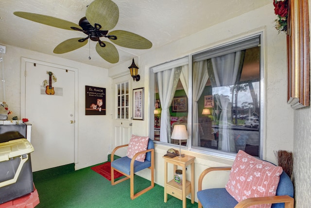 sunroom / solarium featuring ceiling fan