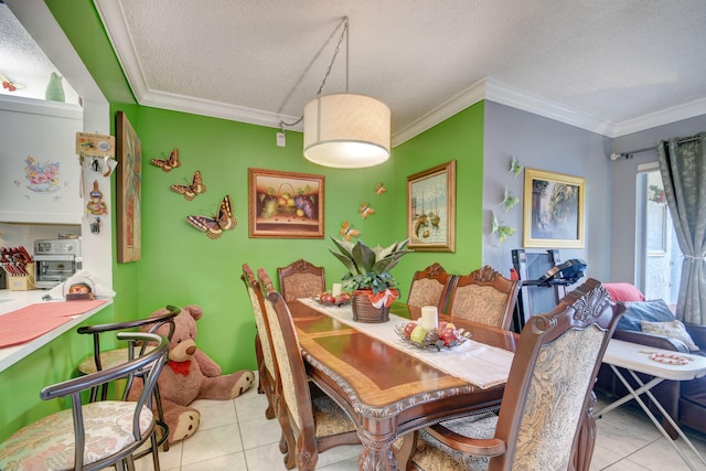 tiled dining area with a textured ceiling and ornamental molding