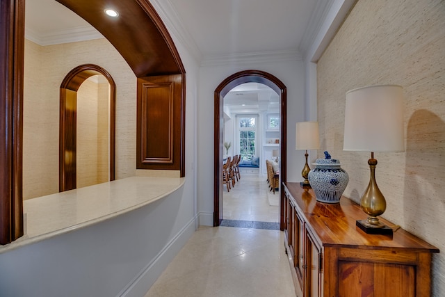 corridor with light tile floors and crown molding