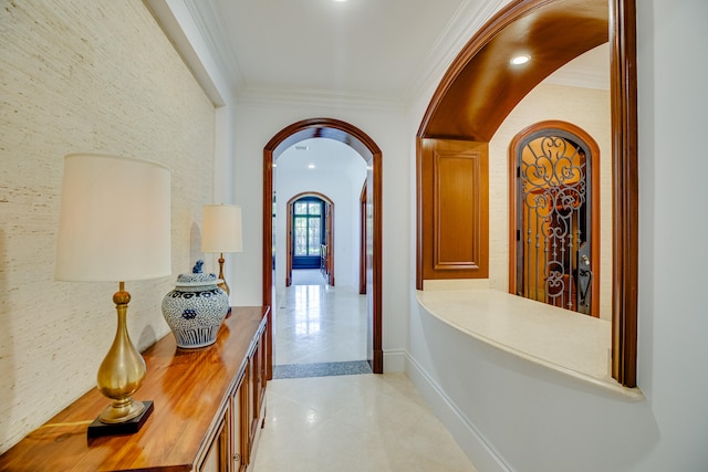 hallway featuring crown molding and light tile floors