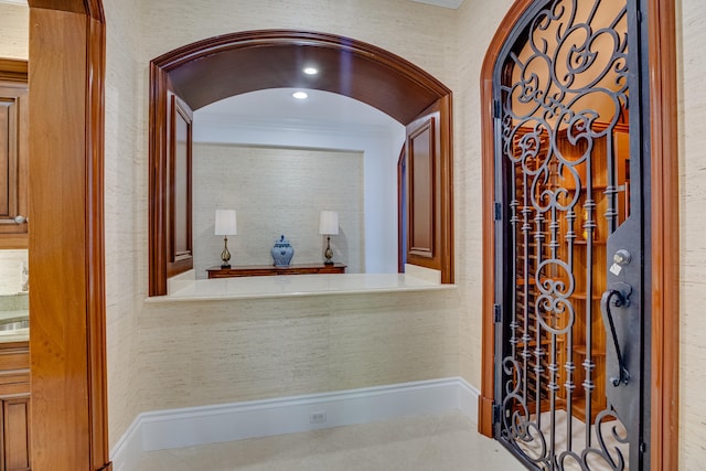 wine room with tile floors and crown molding