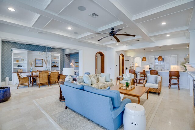 tiled living room featuring beam ceiling, coffered ceiling, ceiling fan, and built in shelves