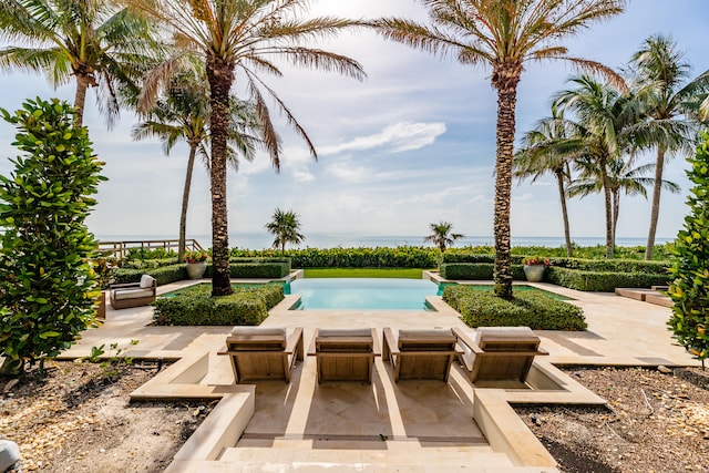 view of swimming pool with a patio and a hot tub