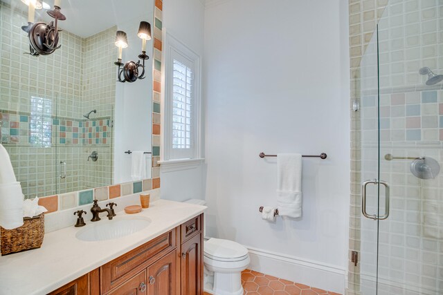 bathroom featuring vanity, tile flooring, toilet, and walk in shower