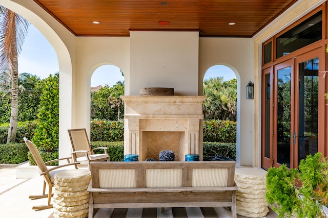 view of patio with an outdoor fireplace and french doors