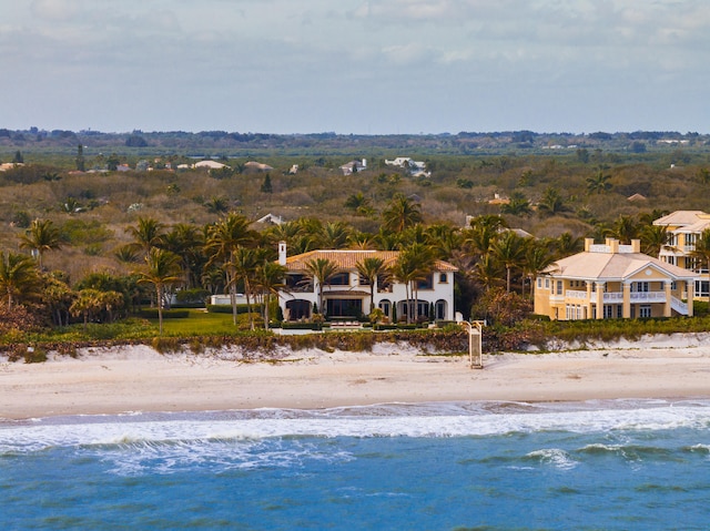 drone / aerial view featuring a water view and a view of the beach