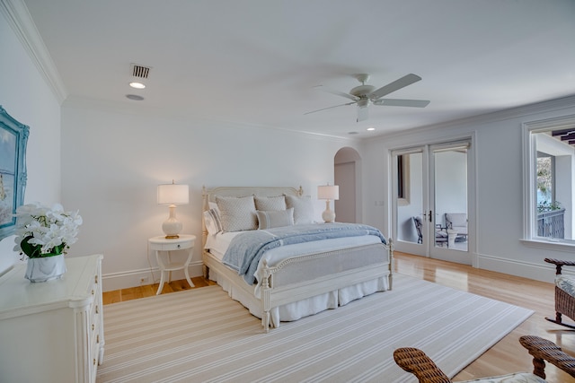 bedroom featuring access to outside, light hardwood / wood-style floors, ceiling fan, and crown molding