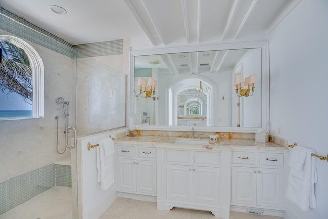 bathroom with plenty of natural light, a tile shower, large vanity, and tile flooring