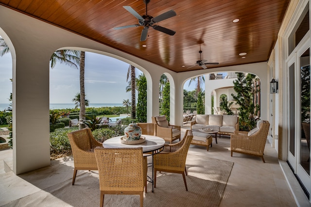 view of terrace featuring a water view, outdoor lounge area, and ceiling fan