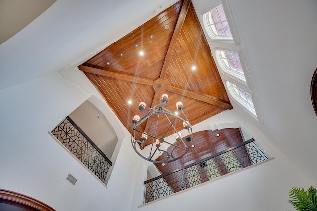 room details with wood ceiling, beam ceiling, and a chandelier