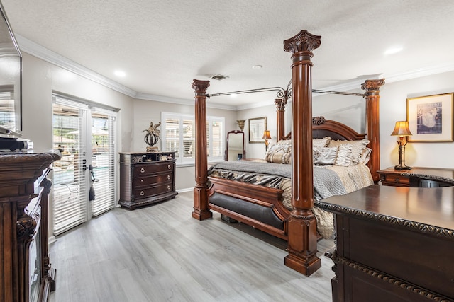 bedroom featuring a textured ceiling, light wood-type flooring, ornamental molding, and access to outside