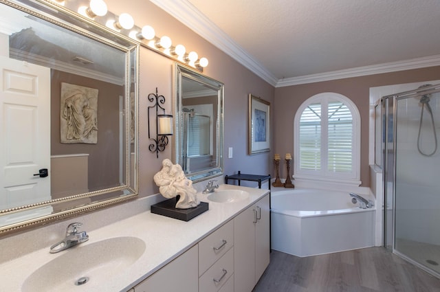 bathroom with vanity, hardwood / wood-style flooring, separate shower and tub, ornamental molding, and a textured ceiling