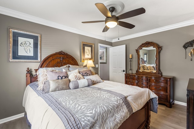 bedroom with hardwood / wood-style floors, ceiling fan, and ornamental molding