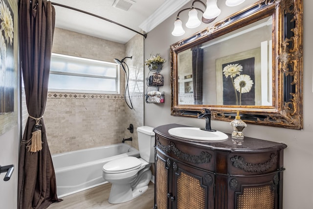 full bathroom featuring vanity, crown molding, hardwood / wood-style flooring, tiled shower / bath combo, and toilet