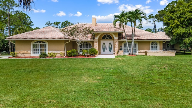 mediterranean / spanish-style house with a front lawn