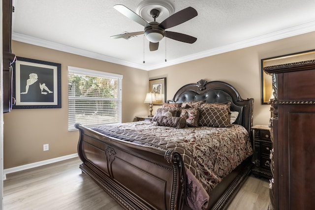 bedroom featuring ceiling fan, ornamental molding, a textured ceiling, and light hardwood / wood-style flooring