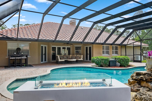 2559 Palm Deer Dr, Loxahatchee, FL 33470 - view of pool featuring a pool with connected hot tub, french doors, outdoor lounge area, a patio, and glass enclosure